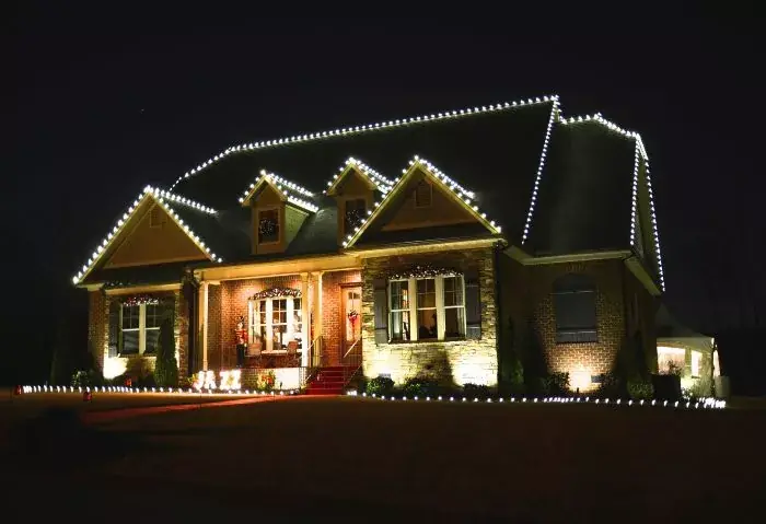 Roofline lights with ground stakes along the front walkway and lawn edge near Bellevue, WA